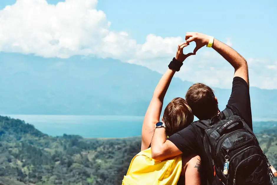 Couple making a heart shape with arms over a beautiful view in Honduras.
